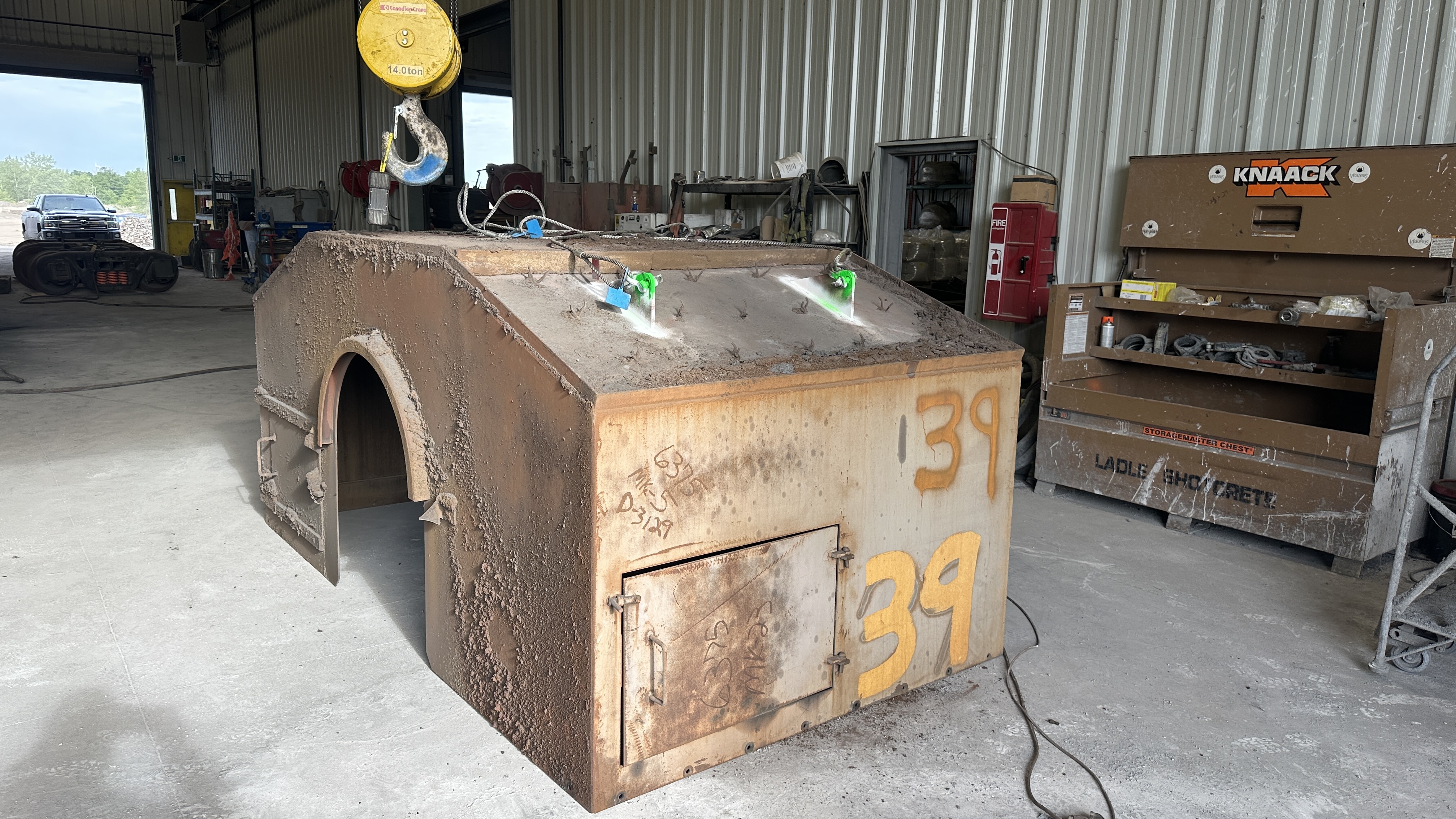 Large fabricated steel enclosure staged in a shop for inspection
