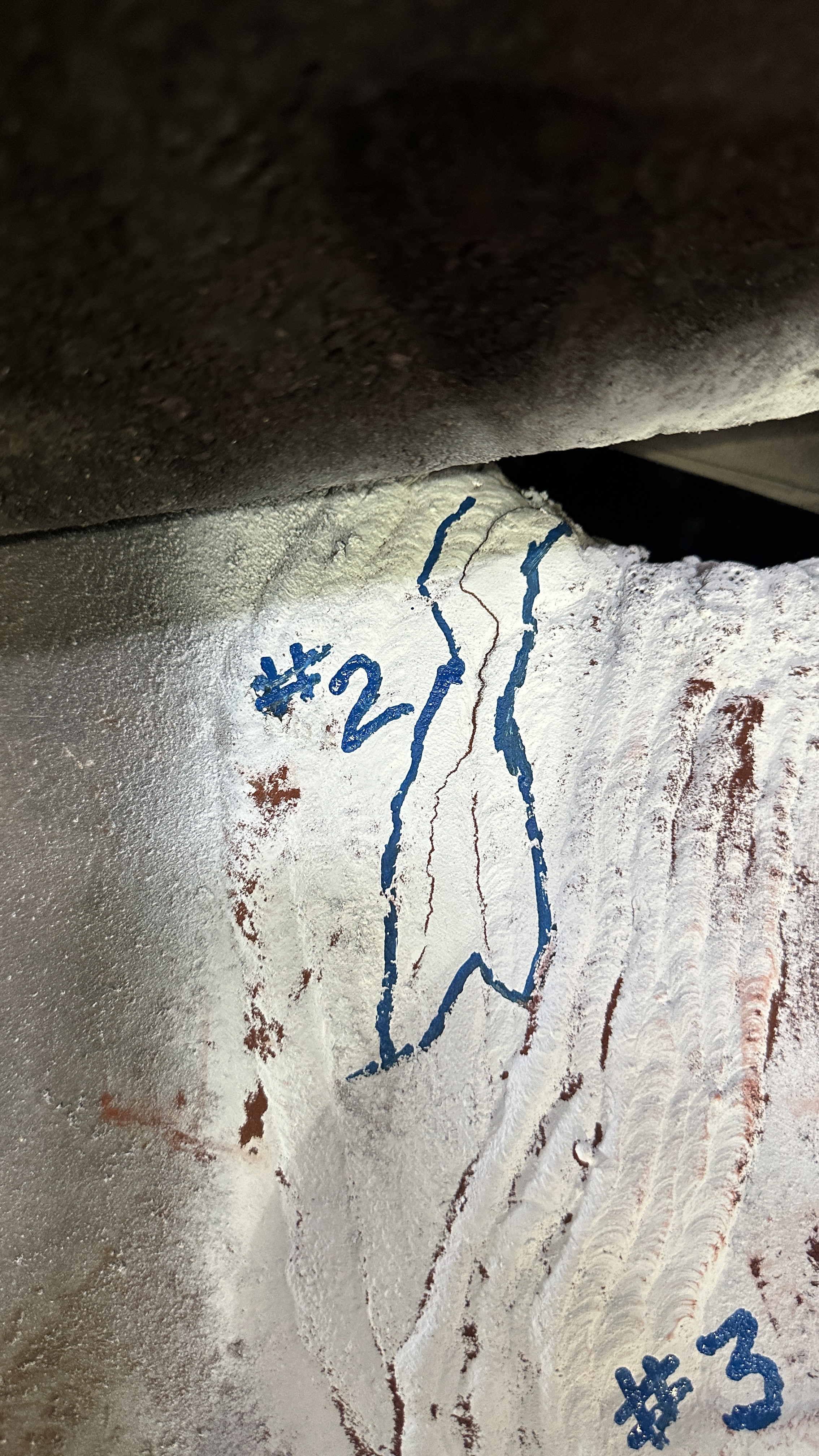 Chalk reference grid marked on an industrial vessel interior for inspection reporting