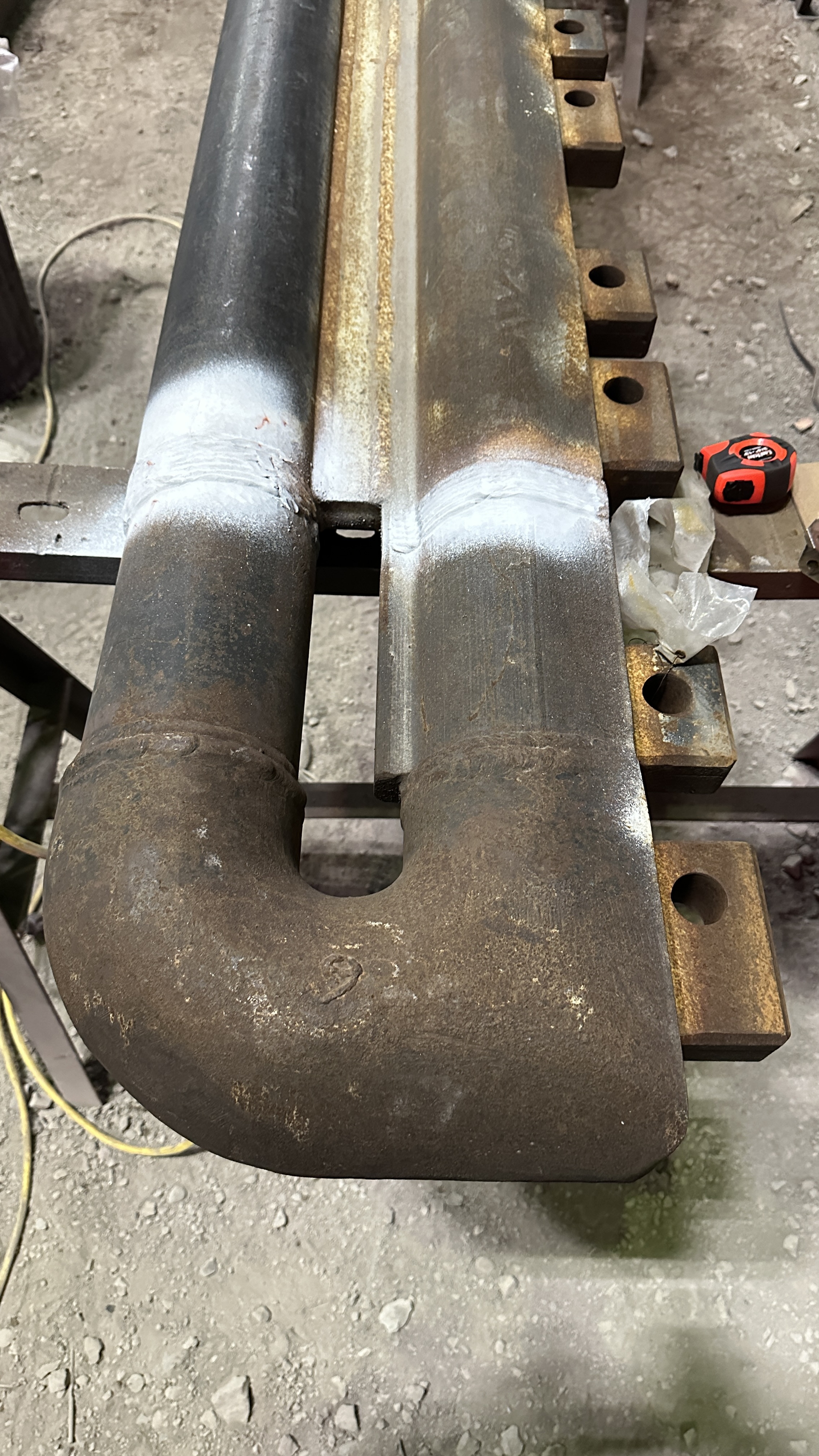 Forged lifting hook assembly staged on a fabrication bench