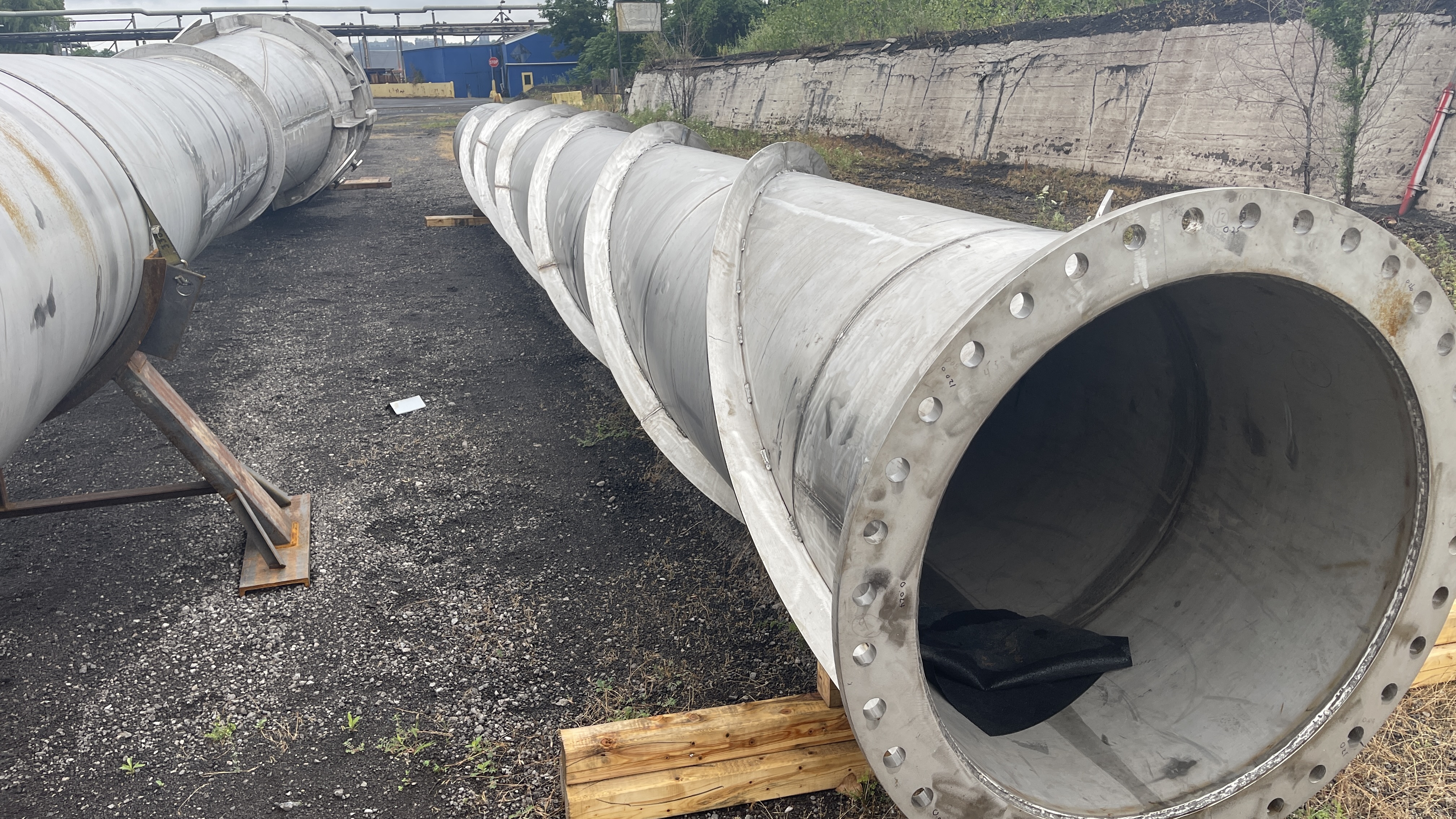 Fabricated stainless steel pipe spools staged in a yard prior to shipment
