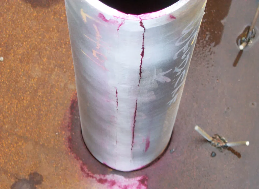 Liquid penetrant crack indication on the end of a pipe fitting